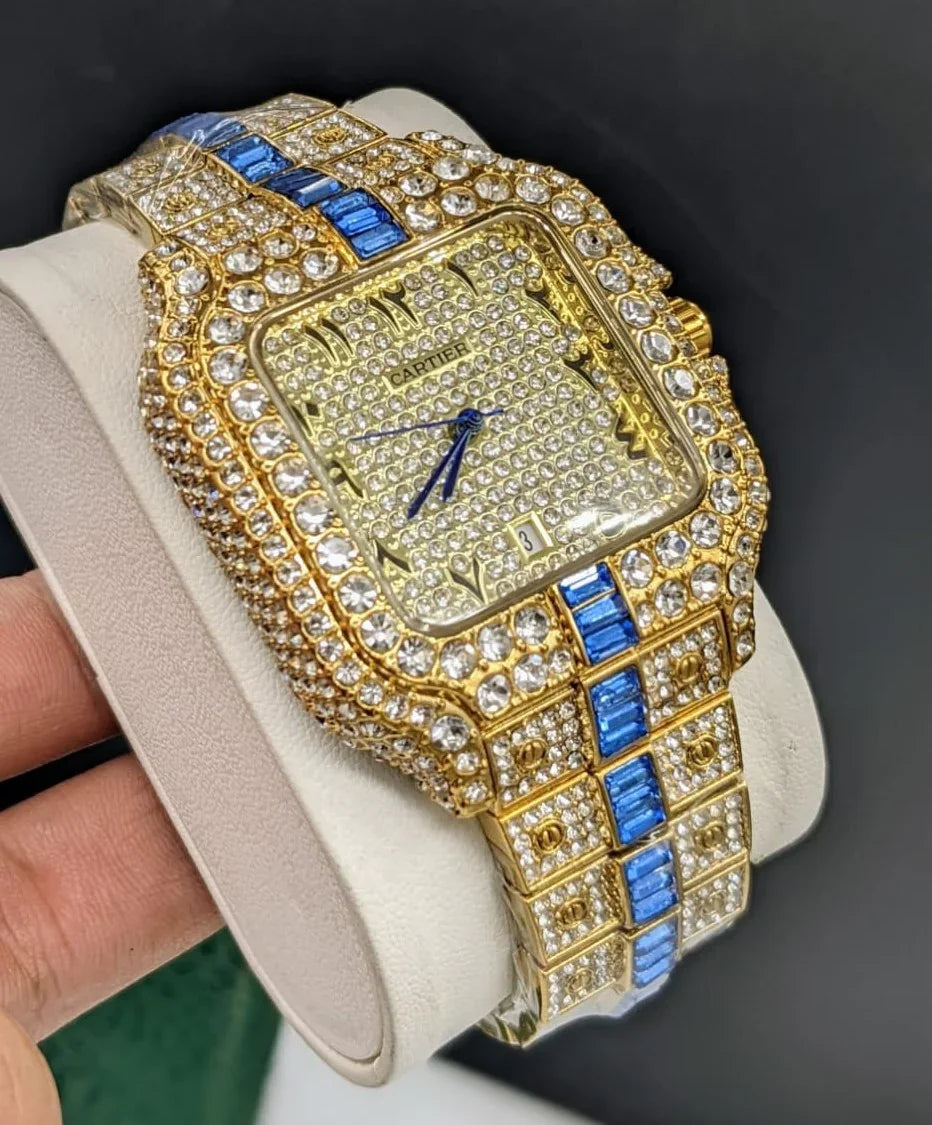 Gold-tone luxury watch with blue accents and diamond-like stones on band and face, elegant style